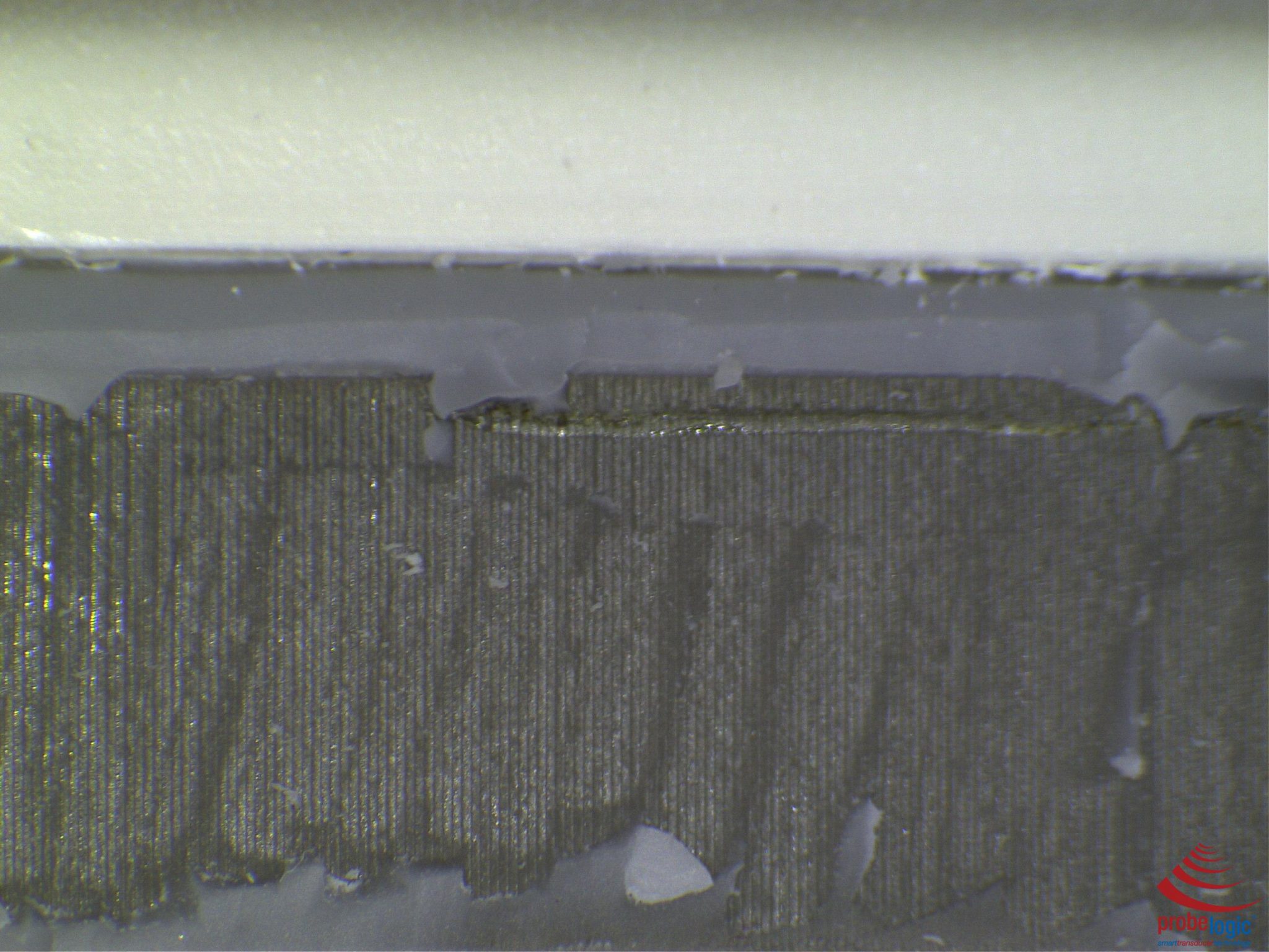 What does a cracked acoustic array look like under a microscope?